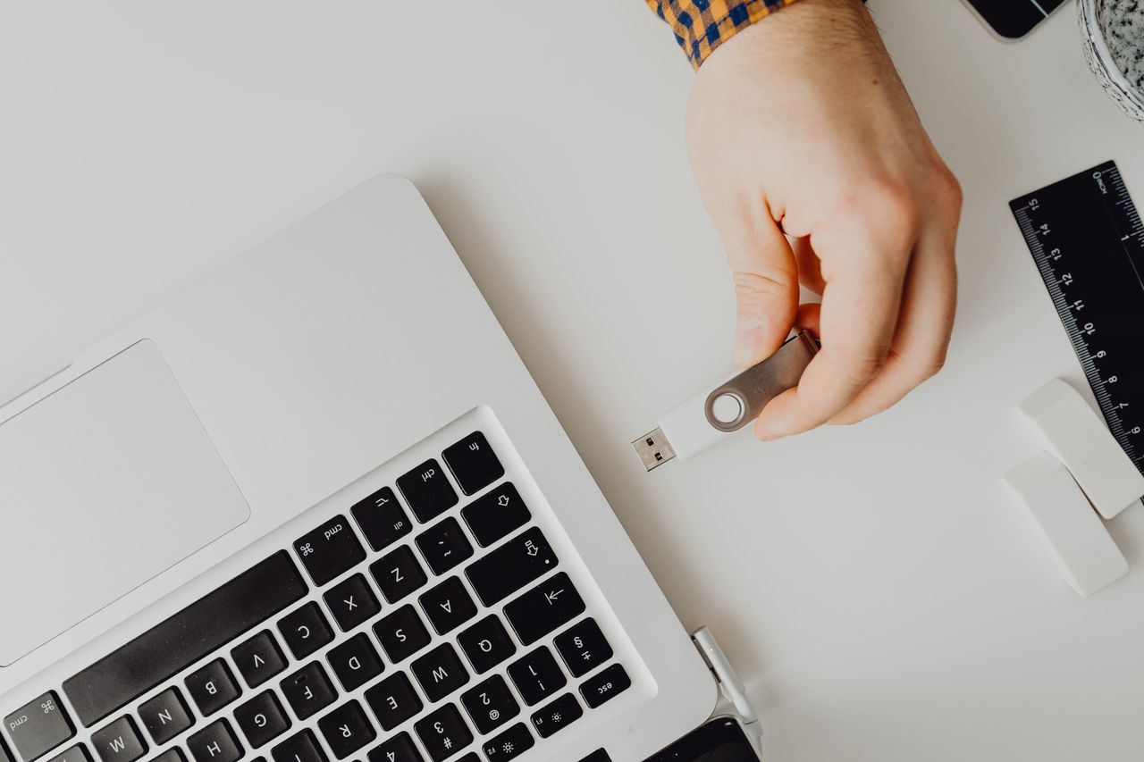 A USB drive being connected to a laptop