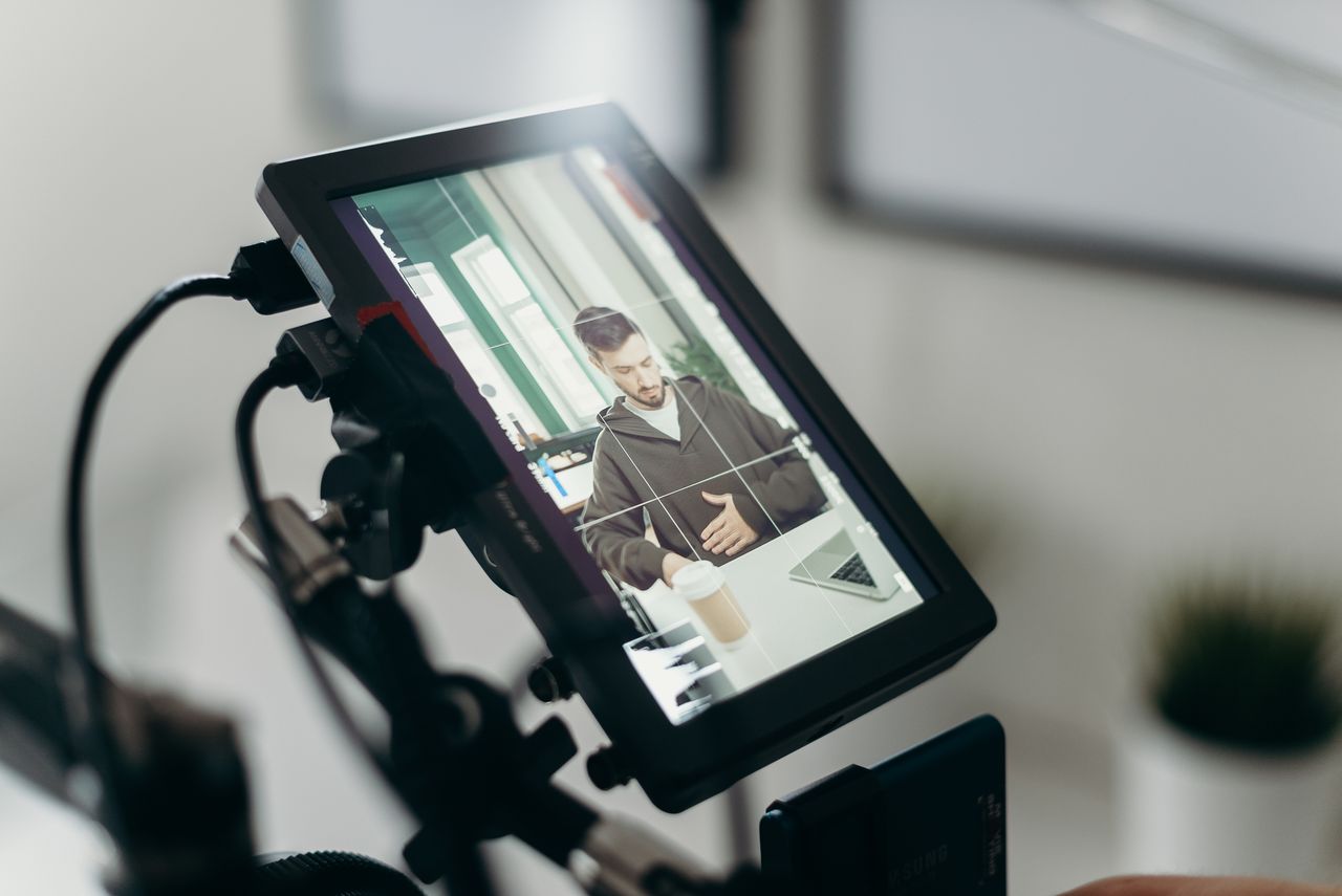 Camera recording a person at a desk